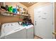 Laundry room with shelving, washer and dryer, and door labeled 'Wash, Dry, Fold, Repeat' at 6922 S 26Th Ln, Phoenix, AZ 85041