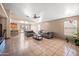 Expansive living room with tile floors and large windows for natural light and dining area at 6922 S 26Th Ln, Phoenix, AZ 85041
