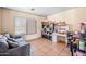 Cozy sitting room with a sofa, large window, and built-in shelving and desk at 6922 S 26Th Ln, Phoenix, AZ 85041