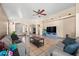 Large living room with tile floors, ceiling fan, and comfortable seating arrangement at 6922 S 26Th Ln, Phoenix, AZ 85041