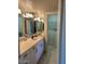 An accessible bathroom features a walk-in tub, a large vanity with a sink and a mirror at 7532 N 23Rd St, Phoenix, AZ 85020