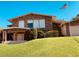 Charming two-story home featuring a stone facade and manicured front lawn with mature landscaping at 7532 N 23Rd St, Phoenix, AZ 85020