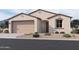 Charming single-story home with a two-car garage, desert landscaping, and neutral color palette at 7691 W Saddlehorn Rd, Peoria, AZ 85383