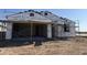 Image of new home construction showing framing with thermal wrap under a clear blue sky at 7691 W Saddlehorn Rd, Peoria, AZ 85383