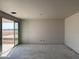 Living room with sliding doors, ready for customization in a new home at 7691 W Saddlehorn Rd, Peoria, AZ 85383