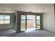 Picture of a living room with sliding glass doors leading to a view of the backyard at 7691 W Saddlehorn Rd, Peoria, AZ 85383