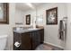 Bathroom with dark wood vanity, framed mirror, and framed floral artwork enhancing a clean, functional space at 7807 E Main St # Cc-98, Mesa, AZ 85207