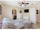 Relaxing bedroom with a ceiling fan, dresser, and a doorway to the bathroom at 7807 E Main St # Cc-98, Mesa, AZ 85207