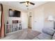 Cozy bedroom with TV, storage, and adjacent rooms provide a comfortable, connected living space at 7807 E Main St # Cc-98, Mesa, AZ 85207
