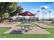 Community park with a picnic table, bocce ball courts and BBQ grills set amongst a manicured lawn at 7807 E Main St # Cc-98, Mesa, AZ 85207