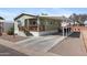 Charming home featuring a covered carport and welcoming front porch with a well maintained yard at 7807 E Main St # Cc-98, Mesa, AZ 85207