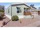 Single story home with light green siding, trimmed in white, complemented by desert landscaping at 7807 E Main St # Cc-98, Mesa, AZ 85207