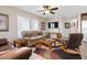 Bright living room featuring a comfortable seating arrangement, ceiling fan, and large windows at 7807 E Main St # Cc-98, Mesa, AZ 85207