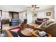 Spacious living area showcasing comfortable seating, stylish rug, and modern ceiling fan at 7807 E Main St # Cc-98, Mesa, AZ 85207