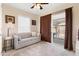 Bright living room with neutral walls, sleeper sofa, ceiling fan, and screened porch access at 7807 E Main St # Cc-98, Mesa, AZ 85207