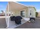 Covered patio with grill, great for outdoor entertaining, adjacent to the home's sliding glass door entrance at 7807 E Main St # Cc-98, Mesa, AZ 85207