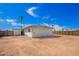 Wide view of the home's large dirt backyard with privacy fence and a tall palm tree at 800 E Melrose Dr, Casa Grande, AZ 85122