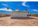 Spacious dirt backyard with fence, palm trees, and a vintage television antenna for local channels at 800 E Melrose Dr, Casa Grande, AZ 85122