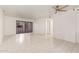 Bright living room with tiled floors, ceiling fan, and a decorative sliding door at 8020 E Thomas Rd # 105, Scottsdale, AZ 85251