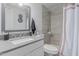 Bright bathroom featuring a vanity, quartz countertop, and updated shower/tub at 8339 W Devonshire Ave, Phoenix, AZ 85037