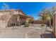 Backyard featuring gravel landscaping, pavers, a covered patio, and desert-friendly plantings at 9644 N 97Th Ln, Peoria, AZ 85345