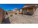 Low maintenance backyard with gravel landscaping, pavers, and a covered patio with outdoor furniture at 9644 N 97Th Ln, Peoria, AZ 85345