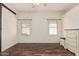 Bedroom featuring wood flooring, natural light from two windows, and a dresser at 9644 N 97Th Ln, Peoria, AZ 85345