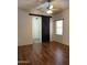 Bedroom with wood floor, barn door, and ceiling fan at 9644 N 97Th Ln, Peoria, AZ 85345