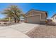 Charming single-story home featuring a two-car garage, mature landscaping, and a spacious driveway at 9644 N 97Th Ln, Peoria, AZ 85345
