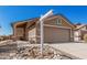 Well-maintained home with a two-car garage, xeriscaping, and a welcoming entrance at 9644 N 97Th Ln, Peoria, AZ 85345