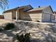 Well-maintained single-story house showcasing desert landscaping, a walkway, and an attached two-car garage at 9644 N 97Th Ln, Peoria, AZ 85345