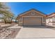 The front of the garage has a light-brown door and a large concrete driveway leading up to it at 9644 N 97Th Ln, Peoria, AZ 85345