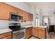 Well-lit kitchen showcasing wood cabinets, stainless steel appliances, and neutral countertops at 9644 N 97Th Ln, Peoria, AZ 85345
