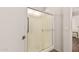 A full shower enclosure with silver hardware, including handles, and a glass door at 9644 N 97Th Ln, Peoria, AZ 85345