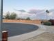 View of a roundabout on a street with block fencing and desert landscaping at 9644 N 97Th Ln, Peoria, AZ 85345