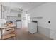 Bright laundry room with washer, dryer, shelving, and storage cabinets at 9905 W Timberline Dr, Sun City, AZ 85351