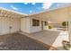 Covered patio and adjacent parking area with a desert landscape, providing shade and outdoor living space at 9905 W Timberline Dr, Sun City, AZ 85351