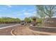 Community entrance with a decorative sign, landscaped area, and a glimpse of the street at 10148 W Avenida Del Rey --, Peoria, AZ 85383