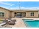 Sparkling pool with a tanning ledge, lounge chairs, and a covered patio with outdoor seating at 10148 W Avenida Del Rey --, Peoria, AZ 85383