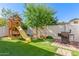 Well-maintained backyard with a playset and outdoor grill, perfect for Gathering fun at 10451 E Natal Ave, Mesa, AZ 85209