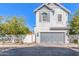 Charming two-story home with a gray garage door and well-kept landscaping at 10451 E Natal Ave, Mesa, AZ 85209