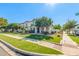 A well-maintained lawn and inviting front exterior, highlighting the charming two-story gray and white home at 10451 E Natal Ave, Mesa, AZ 85209