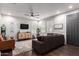 The living room showcases wood floors, a ceiling fan, and stylish furniture under natural light streaming through the windows at 10451 E Natal Ave, Mesa, AZ 85209