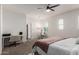 A spacious main bedroom showcases natural light, a ceiling fan, and a dedicated workspace at 10451 E Natal Ave, Mesa, AZ 85209