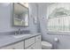 Bright bathroom featuring a sink vanity and large mirror and shower with support bar at 10516 W El Capitan Cir, Sun City, AZ 85351