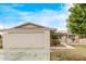 Ranch-style home showcasing a large garage and well-maintained front yard at 10516 W El Capitan Cir, Sun City, AZ 85351