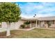 Charming single-story home featuring a well-manicured lawn and decorative front yard fence at 10516 W El Capitan Cir, Sun City, AZ 85351