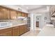 Bright kitchen with wood cabinets, tile backsplash, and modern appliances including a built-in oven at 10516 W El Capitan Cir, Sun City, AZ 85351