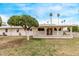 Charming home featuring a covered patio and lush greenery in the backyard at 10516 W El Capitan Cir, Sun City, AZ 85351