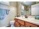 The bathroom showcases a wood vanity and a large mirror to maximize space at 1155 S Annie Ln, Gilbert, AZ 85296